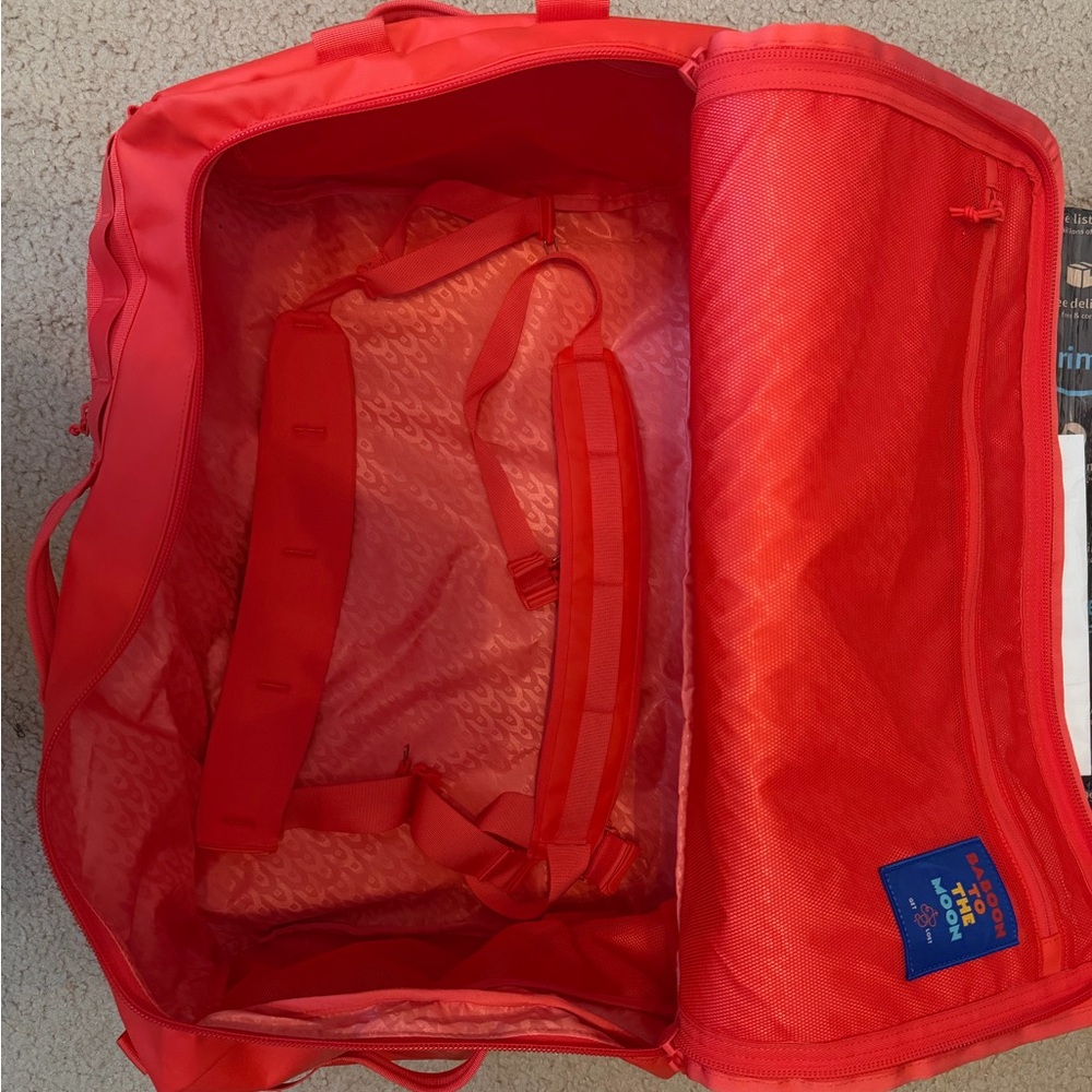 Baboon to the Moon tangerine Go bag 60L